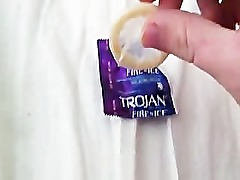 Hard cock wrapped up in condom.