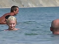 Beautiful fresh faced teen plays at the beach nude