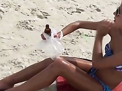 Lesbian amateur gets a hot body massage at the beach