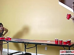 Two beautiful girls play strip beer pong